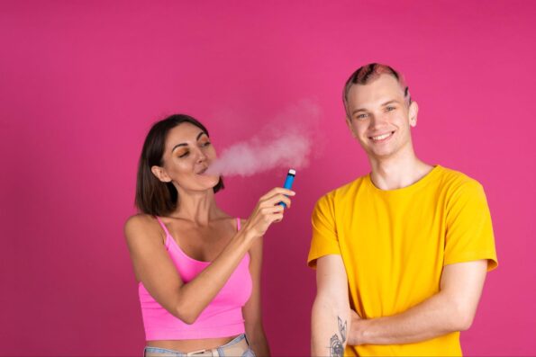 A beautiful lady offering vape to her boyfriend