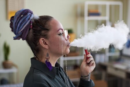 A woman is enjoying vaping