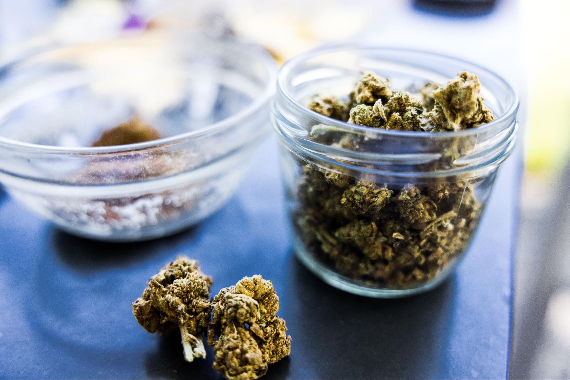 Cannabis buds in a jar and in a bowl.