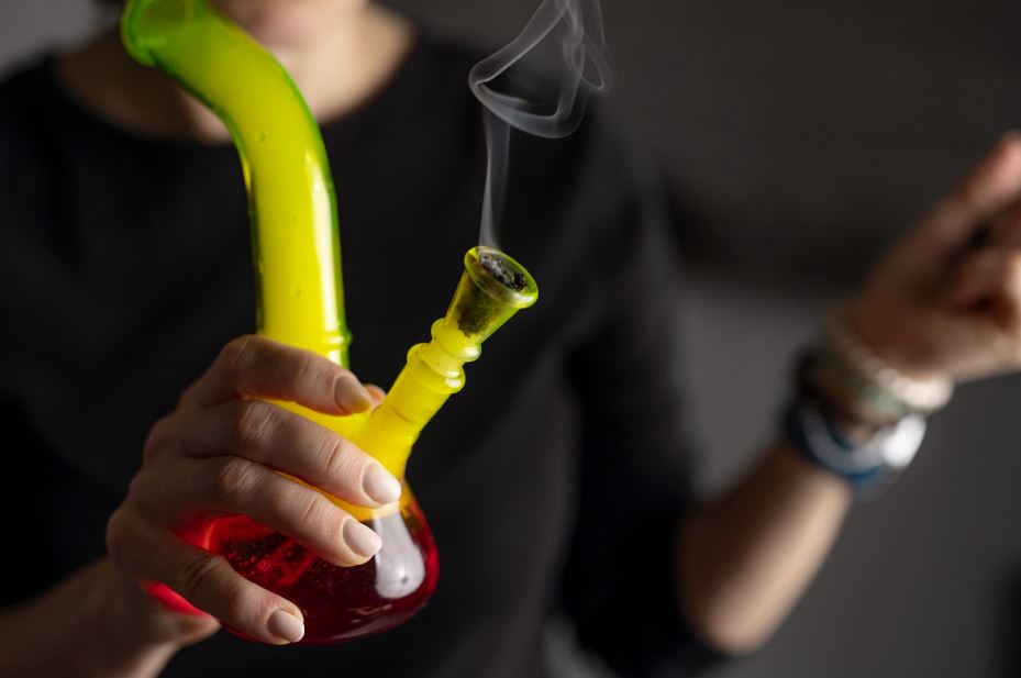 Woman holding a bong. Woman holding a bong.