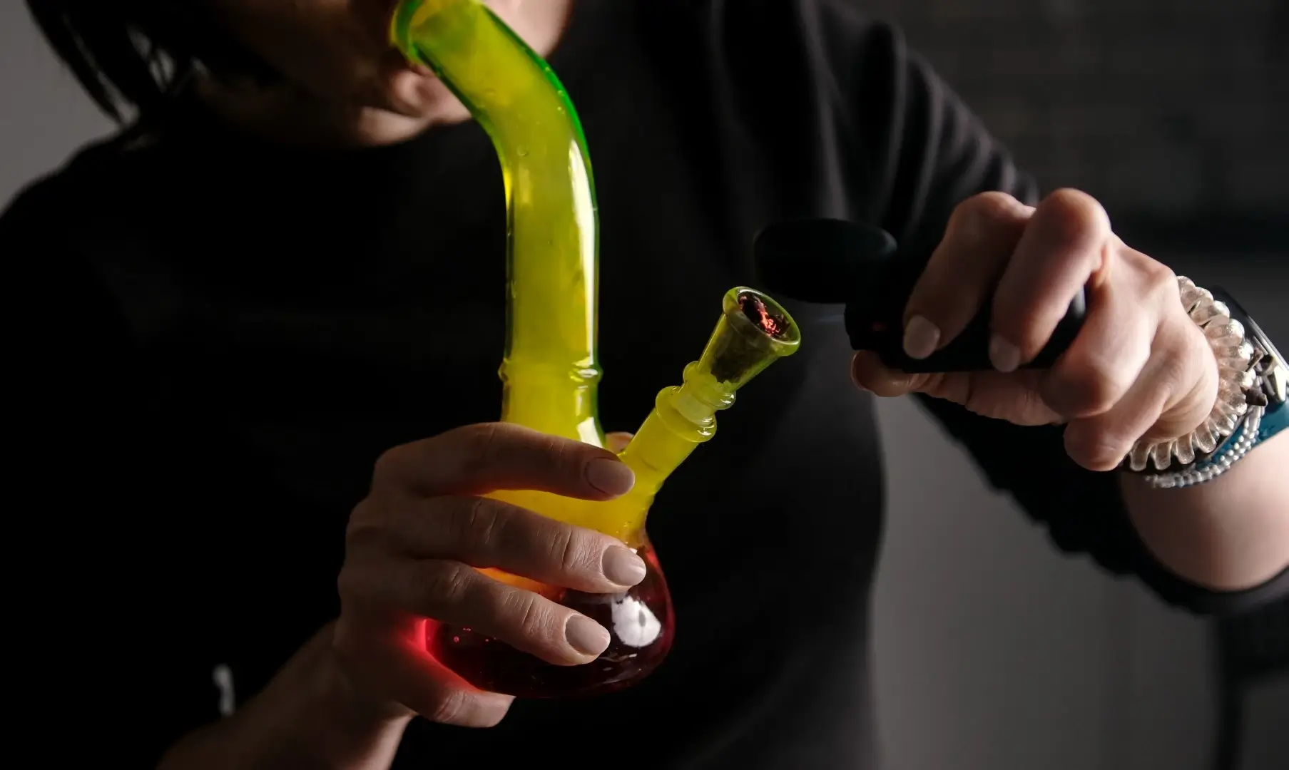 Woman filling a bong.