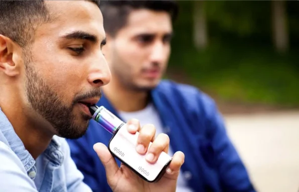 man using a vaping device.