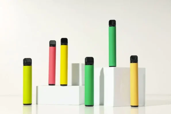 Multi colored vape devices on box shaped pedestals.