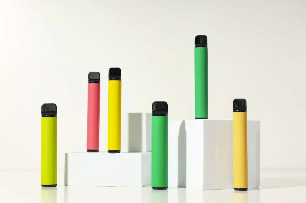Multi colored vape devices on box shaped pedestals.