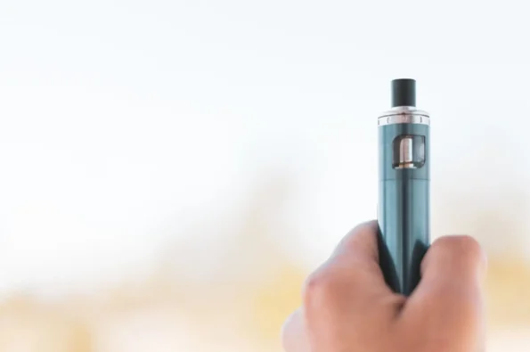 A hand holding a vape stick.