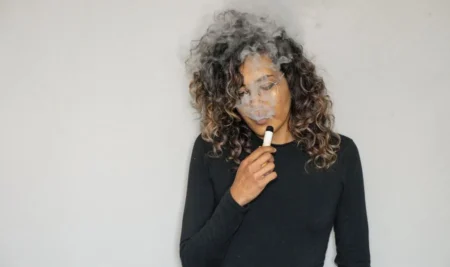 woman using a vape pen